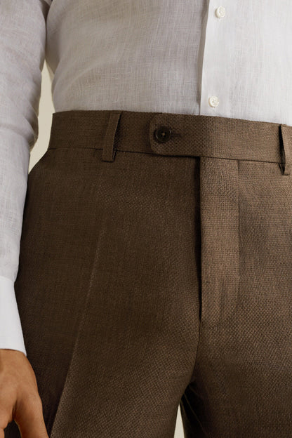 Brown textured trousers close-up: belt loops, waistband tab, front button