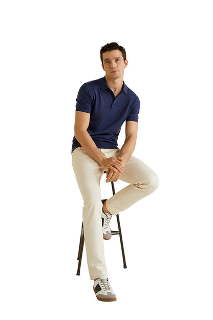 Navy knit polo shirt with short sleeves, worn by model