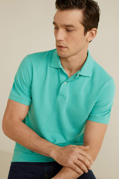 Turquoise men's polo shirt close-up: polo collar and button placket, short sleeve