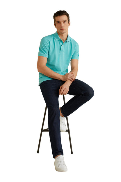 Turquoise men's polo shirt on model sitting, short sleeves and button placket