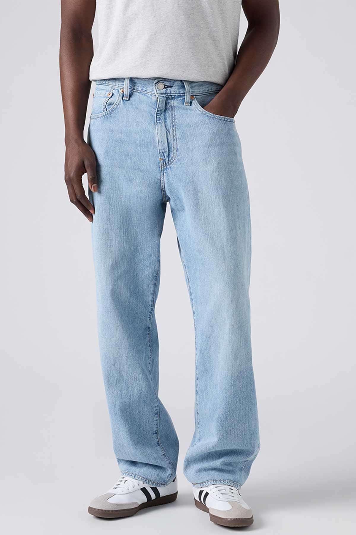 Levi's light-wash denim jeans, waistband and front pocket close-up, straight legs