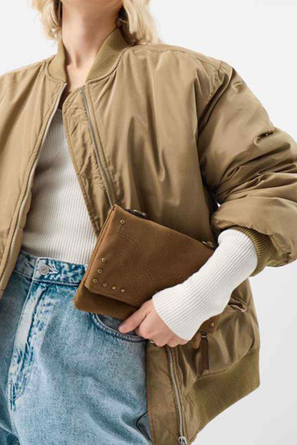 Tan crossbody bag with studded flap and adjustable strap