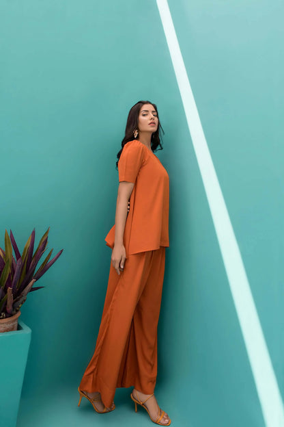 Orange velour tunic and wide-leg pants, three-quarter view standing