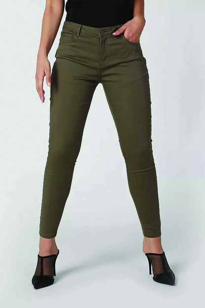 Olive green slim-fit jeans close-up, button-and-zip fly, ankle length