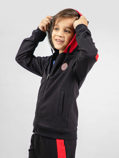 Black kids zip hoodie with hood, red inner trim, and round logo patch
