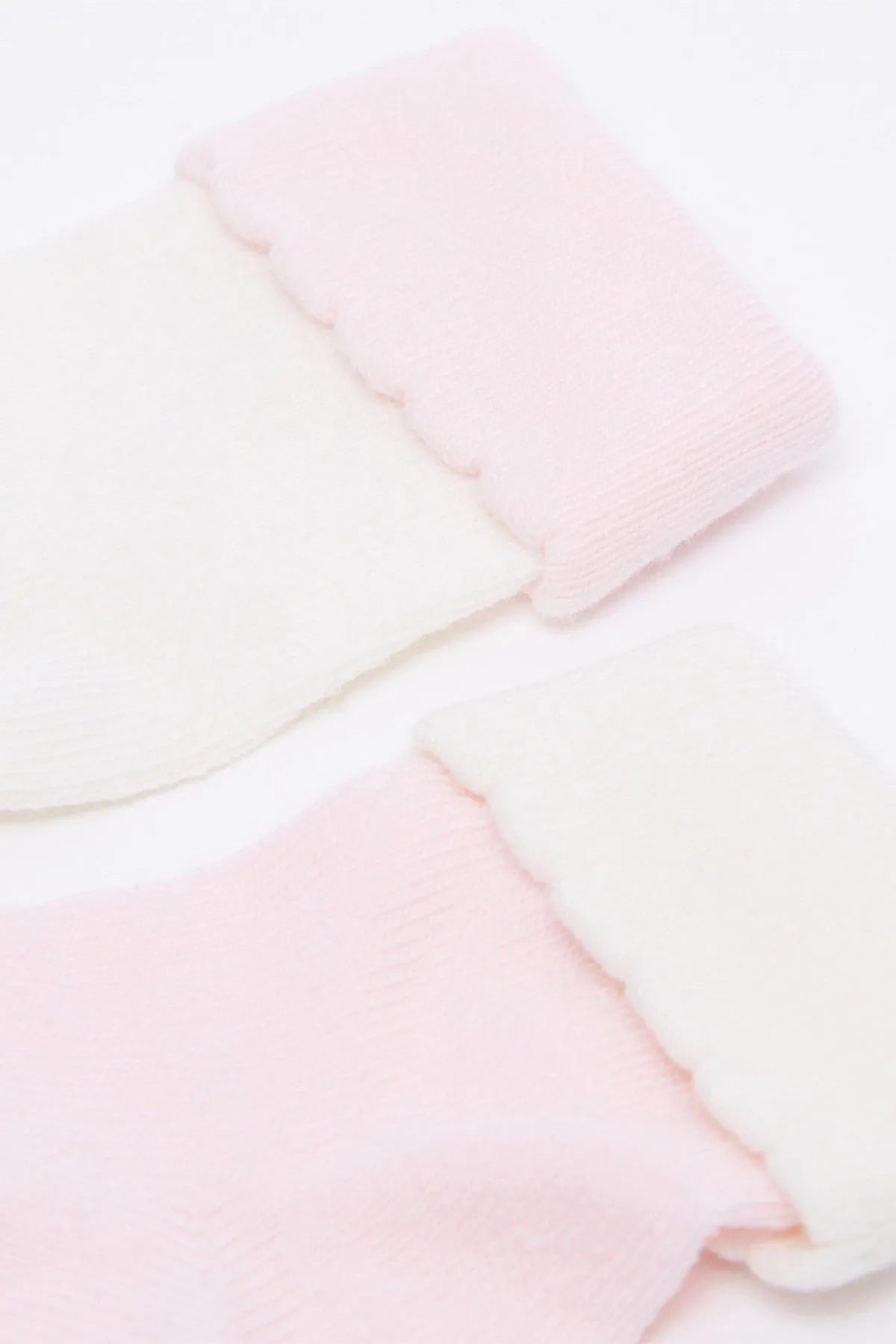 Close-up of pink baby knit crew socks with soft ribbed cuff