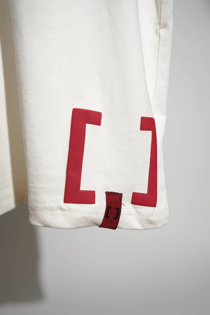 Off-white T-shirt front hem close-up with red bracket print
