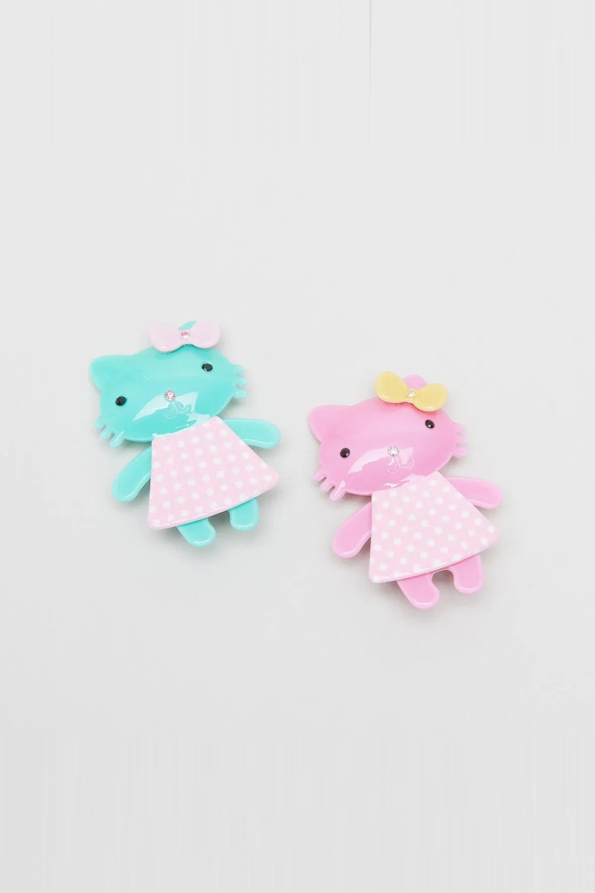 Set of dinosaur character hair clips, blue and pink with polka-dot dress