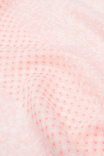 Close-up of pink scarf fabric with small repeating pattern