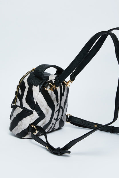 Black and white zebra print mini crossbody bag with gold-tone hardware and strap