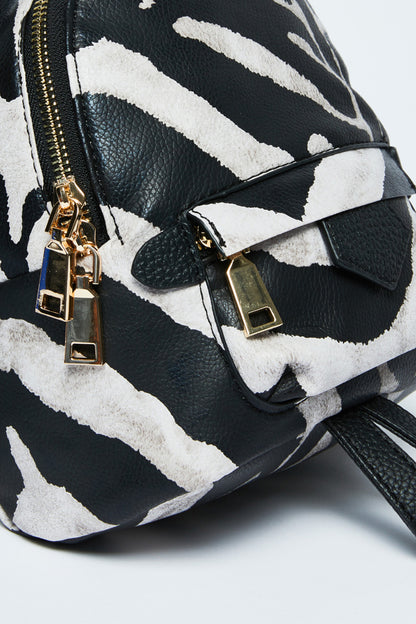 Zebra print mini shoulder bag close-up with gold-tone clasp, zipper pulls, and buckle