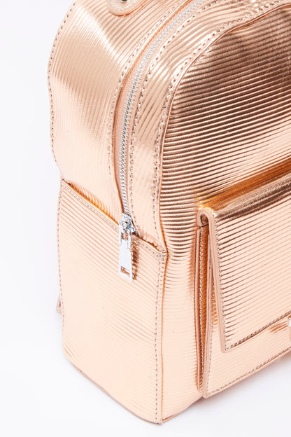 Rose-gold pink mini backpack close-up with textured stripes and front zipper pocket