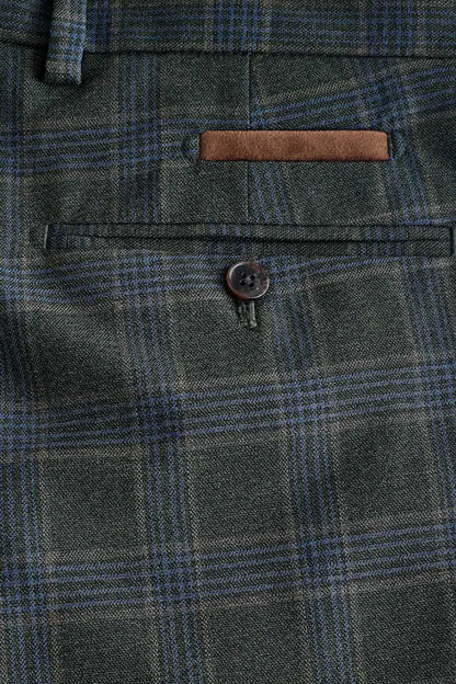 Green plaid suit trousers close-up of front pocket and round button
