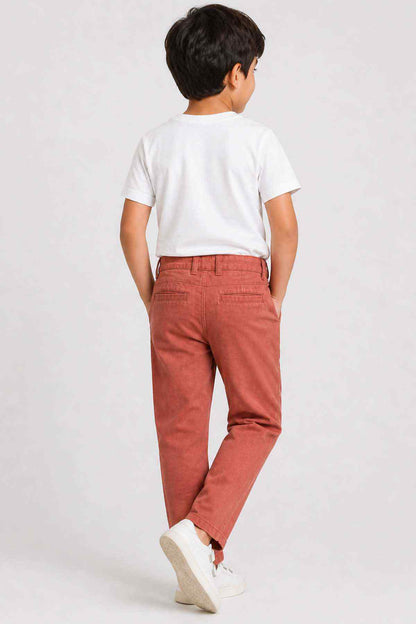 Kids' orange cotton trousers, back view with button waist and ankle-length straight legs
