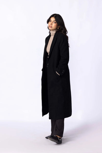 Black long coat with notched lapels and long sleeves; side view with buttons.