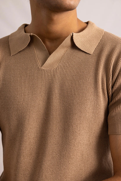 Brown knit polo shirt close-up: ribbed collar and textured knit fabric