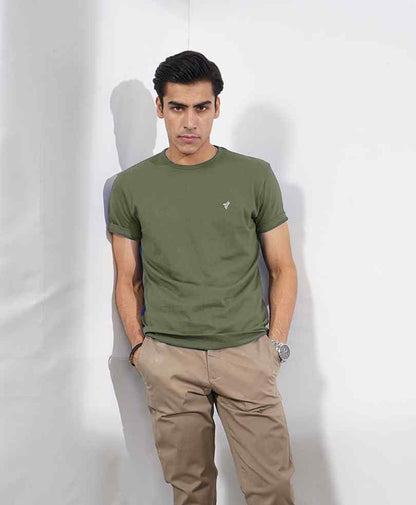 Fitted olive green T-shirt with small chest logo, crew neck short sleeves paired with tan chinos