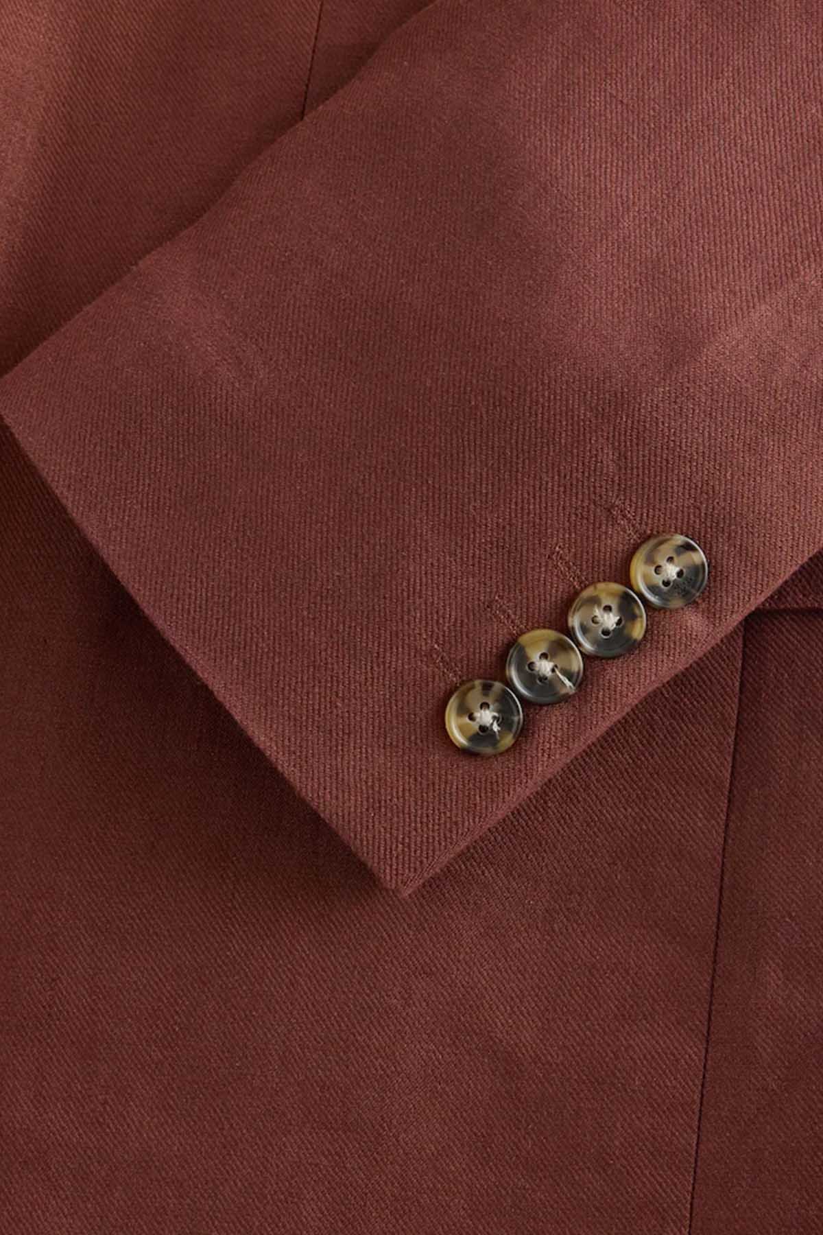 Brown suit jacket cuff buttons and stitched buttonhole detail
