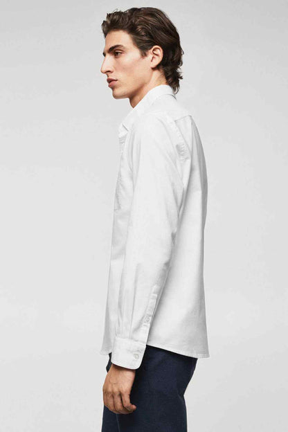 White long-sleeve button-up shirt in side profile with button cuffs