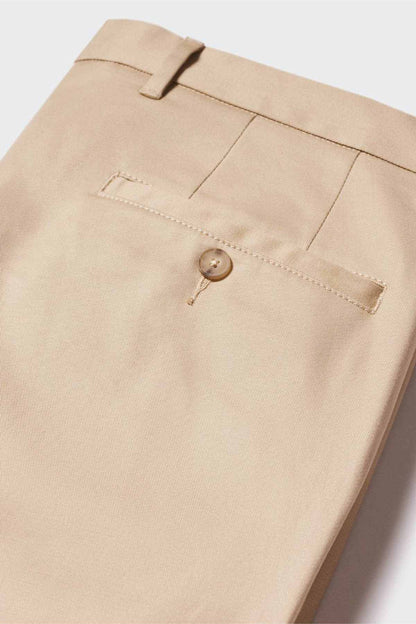 Beige chino pants fabric close-up with stitched pocket flap and button