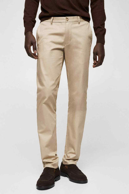 Beige chino pants with belt loops, button fly, and side pockets