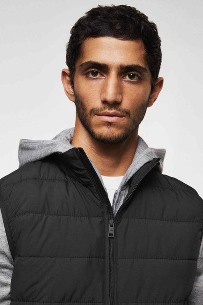 Men's black quilted vest with front zip and high collar, hooded
