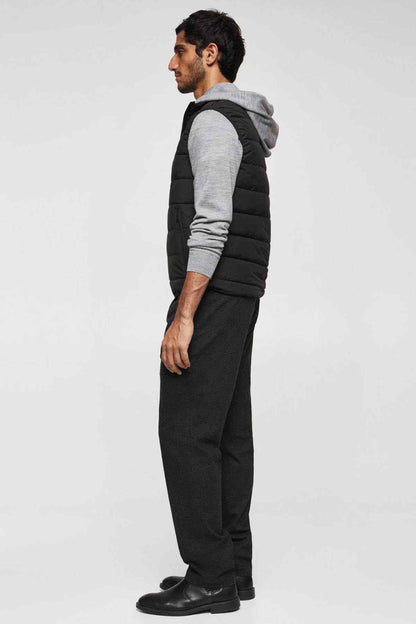 Men's black quilted vest with hood, side profile, sleeveless design