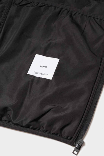 Black quilted vest fabric with brand label and zip at hem