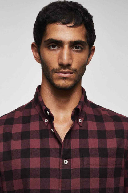 Men's plaid button-up shirt close-up with red-and-black check pattern