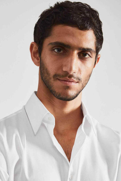 White dress shirt collar and top buttons, worn open at neckline