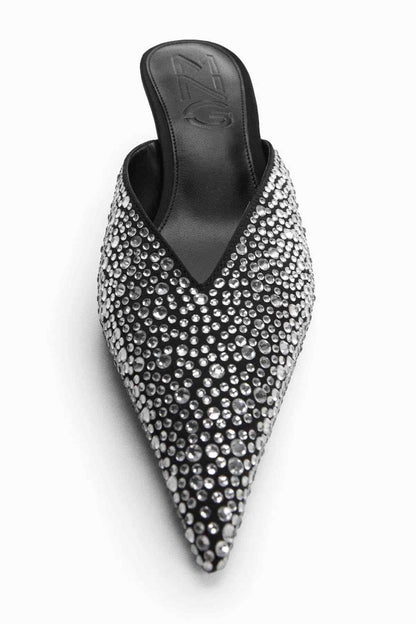Pointed-toe heeled mule with silver rhinestone upper and black insole, front close-up