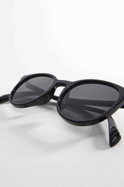 Black cat-eye sunglasses with dark lenses, close-up front angle