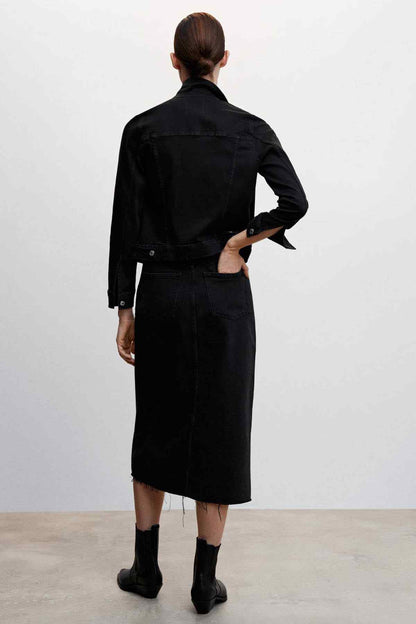 Back view of black denim jacket with button closure and structured yoke seam.