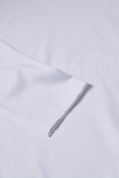 Detail of white long-sleeve top fabric and hem stitching