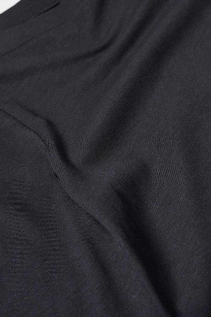Black top fabric close-up with fine texture and soft drape