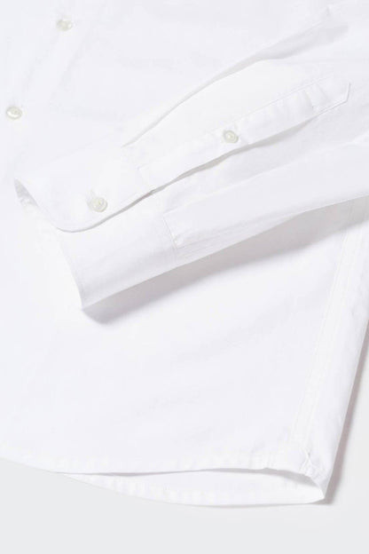 White dress shirt sleeve with button cuff and stitched placket, close-up