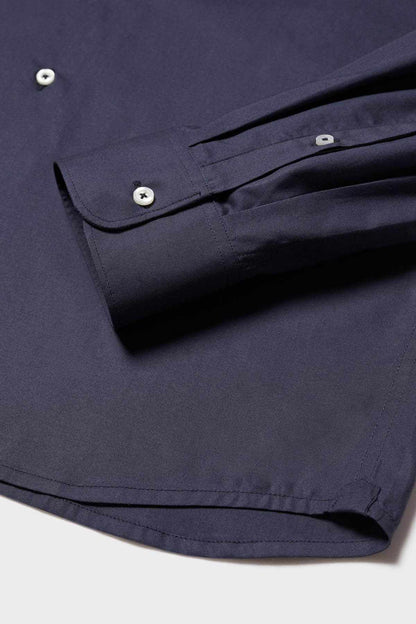 Navy button-up shirt cuff detail with single button and stitched hem