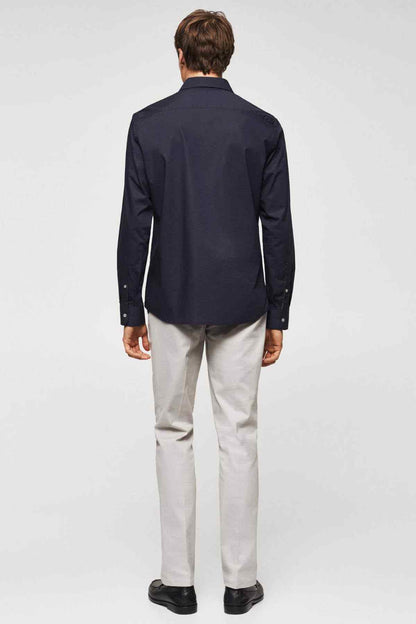 Navy button-up shirt, back view with pointed yoke and full-length sleeves