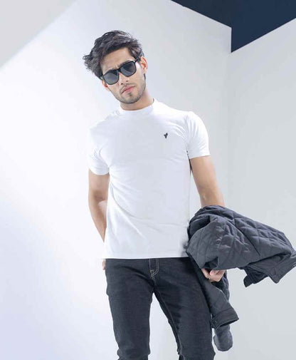 Fitted white crew-neck T-shirt with small chest logo, short sleeves; jacket draped on shoulder