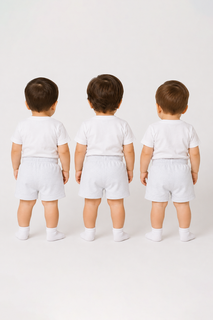 Back view of toddlers wearing white baby socks with ribbed cuffs