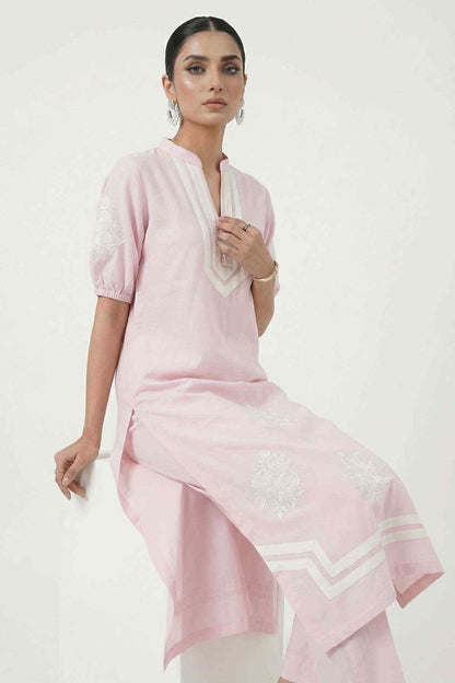 Light pink kurta set with white-trim neckline, embroidered motifs, and matching pants