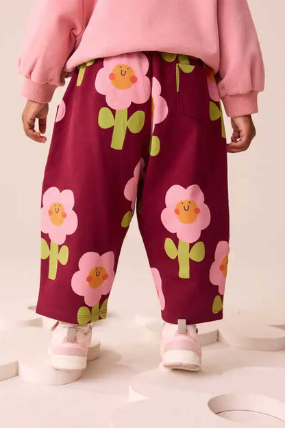 Kids burgundy floral print pants with elastic waistband and straight leg, front view