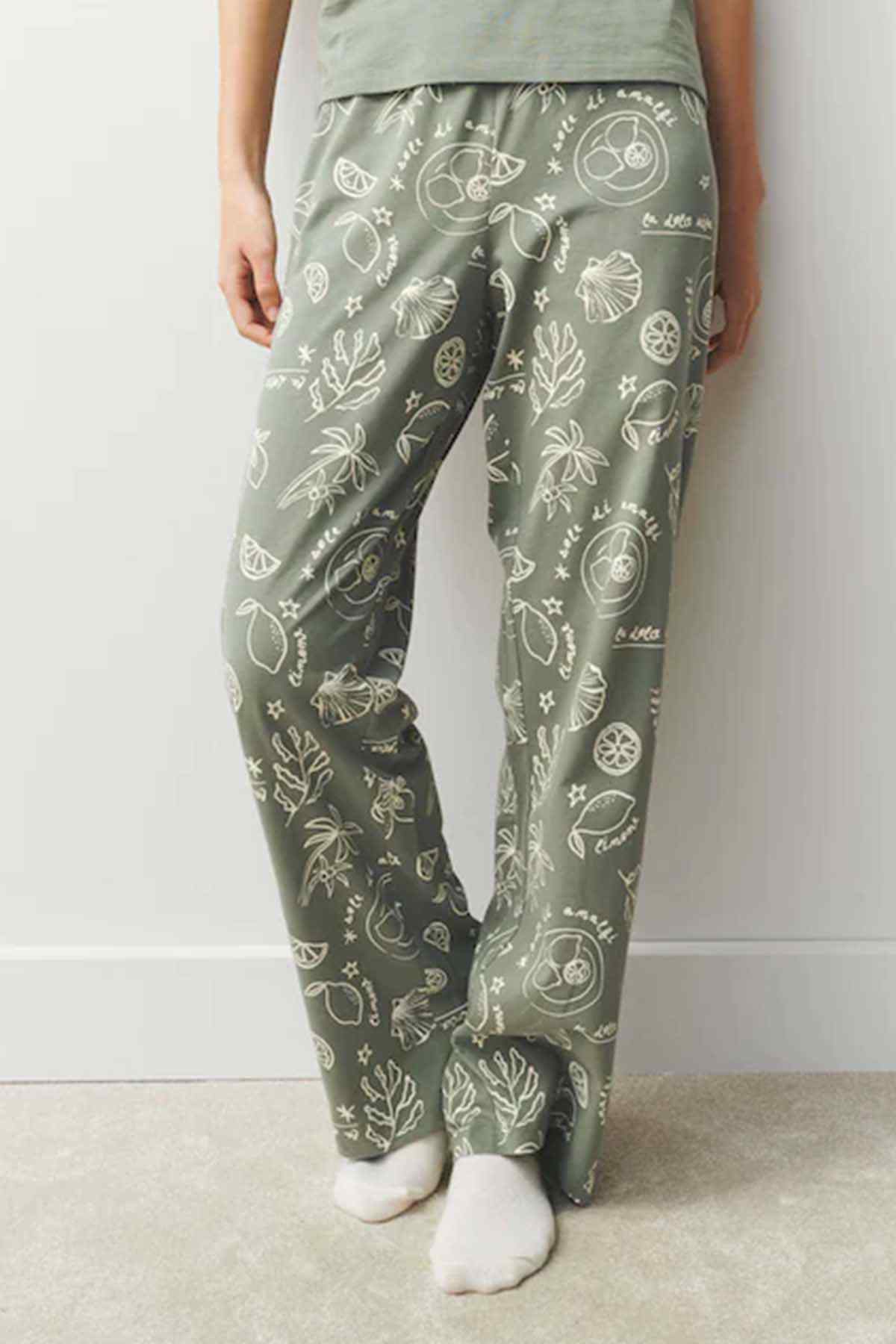 Sage green pajama trousers with white illustrated print and elastic waist