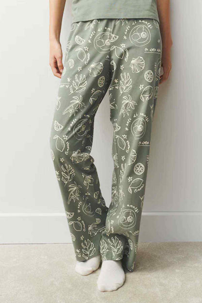 Sage green pajama trousers with white illustrated print and elastic waist