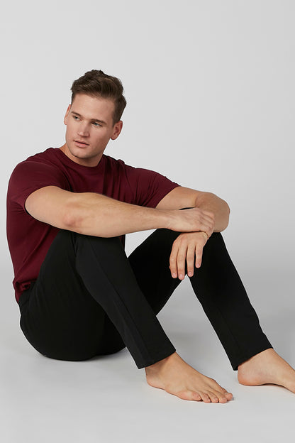 Black jogger pants with drawstring waist, slim tapered legs, ankle cuffs