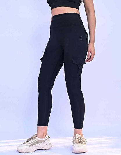 Back view black cargo leggings with hip pocket flaps and slim leg opening.
