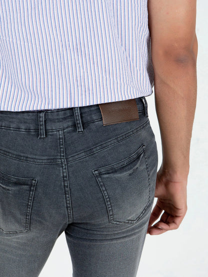 Brumano men's grey jeans detail: back pockets and tan waistband patch