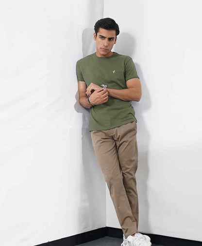 Fitted olive green crewneck T-shirt with small logo, tan chinos
