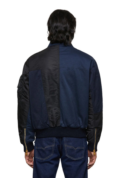 Blue bomber jacket back view with patch panels and zip pockets at sides