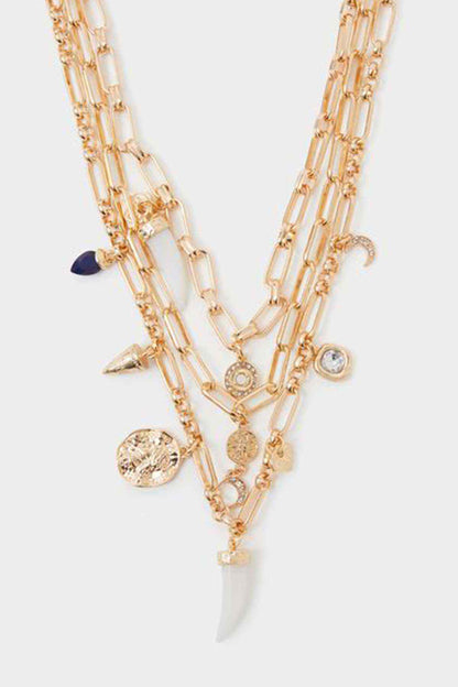 Gold-tone layered charm necklace with star, coin and blue charm details